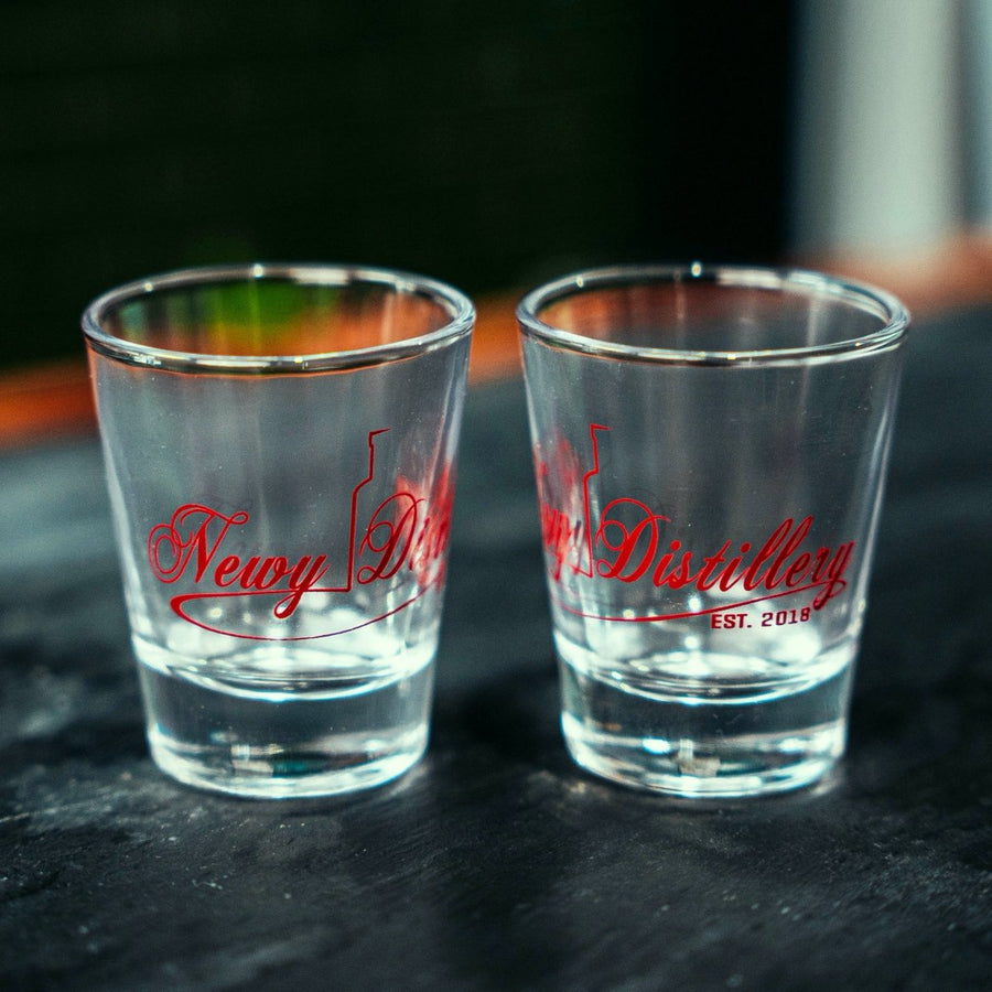 50ml shot glasses by Newy Distillery. Empty glasses on grey slate.