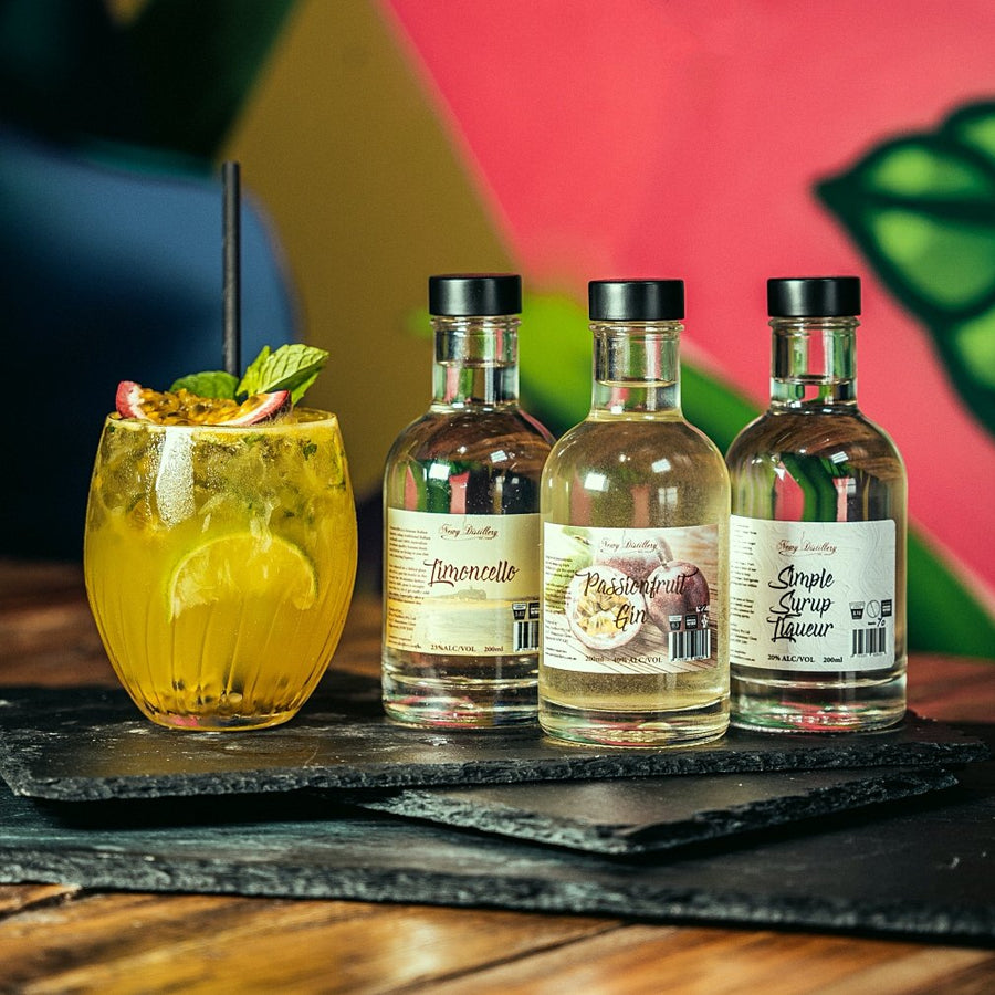 Passionfruit Gin Caipiroska Cocktail Kit by Newy Distillery. 3x 200ml bottles displayed with Passionfruit Gin Caipiroska cocktail.